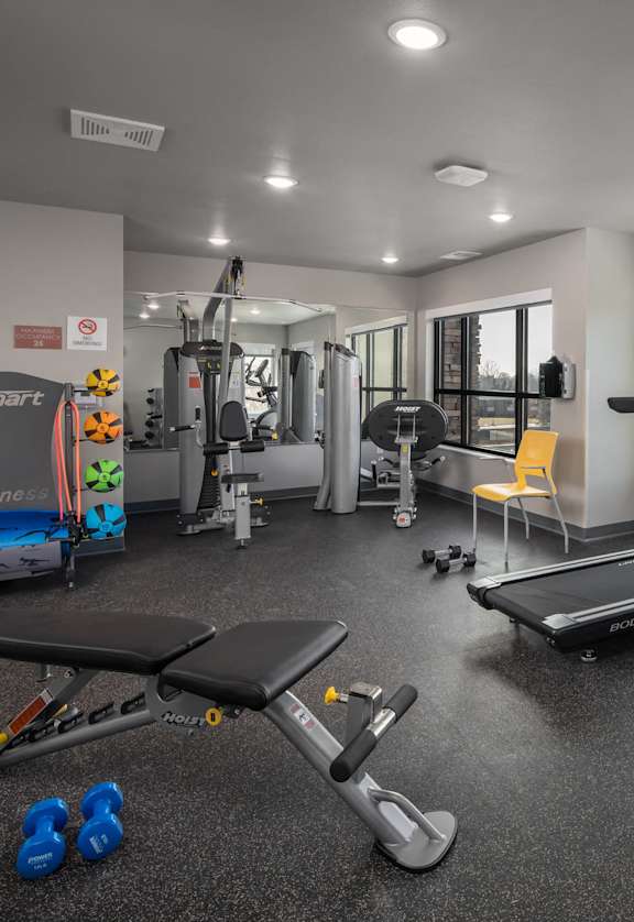 a gym with treadmills and other exercise equipment at the enclave at university heights