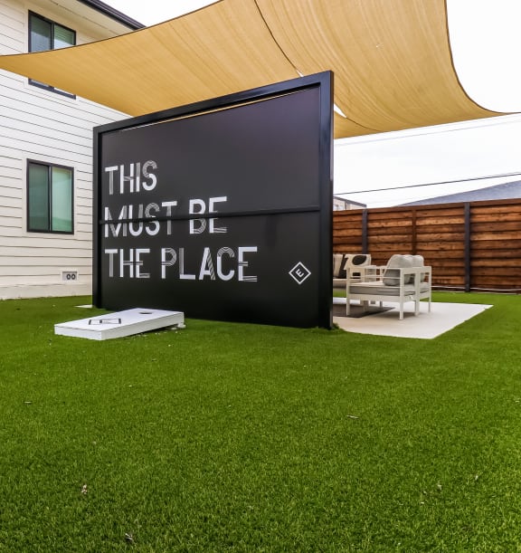 a large sign that says this must be the place on the lawn of a house at The Eastern Apartments, Texas, 75204