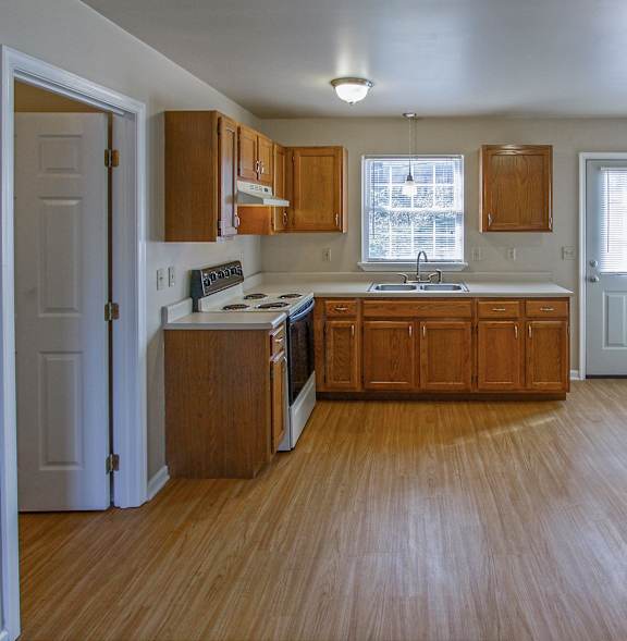 A kitchen with black appliances and white countertops.