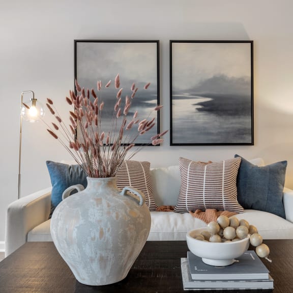 a living room with a couch and a table with a vase at The Austin Apartment Homes, New Jersey