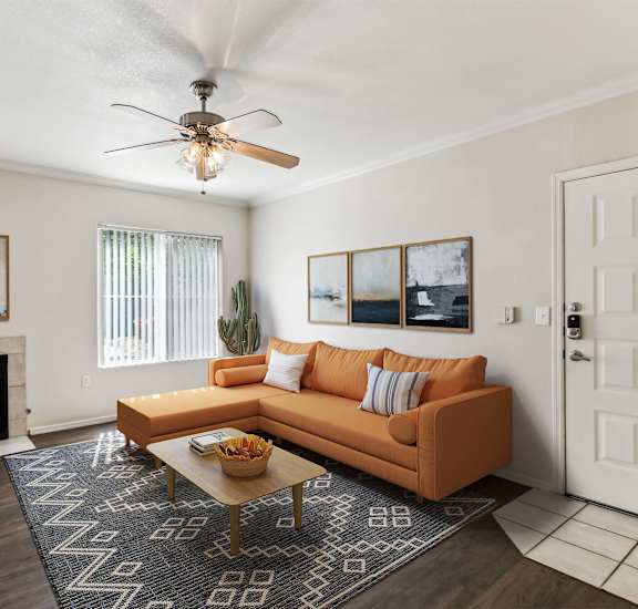a living room with a couch and a ceiling fan