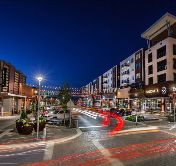a city street at night with cars and buildings at Slate at Fishers District, Fishers, 46037