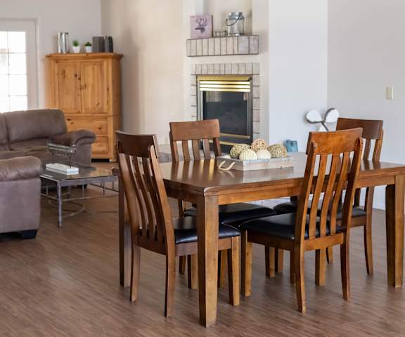 a living room and dining room with a wooden table and chairs at Pines at Prescott Apartments, Prescott, Arizona