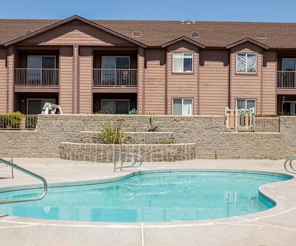 a swimming pool with a building in the background at Pines at Prescott Apartments, Prescott, AZ