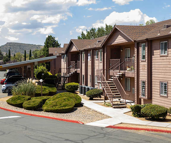 A row of houses with a mountain in the background at Pines at Prescott Apartments, Prescott, AZ 86305