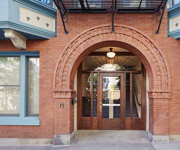 A red brick building with a large arched doorway.