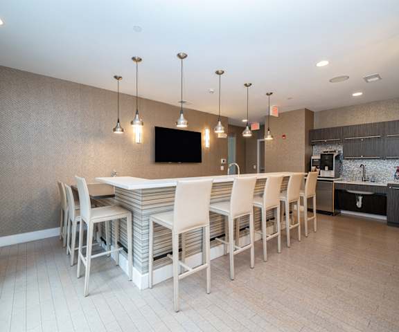 a dining room with a long table and chairs