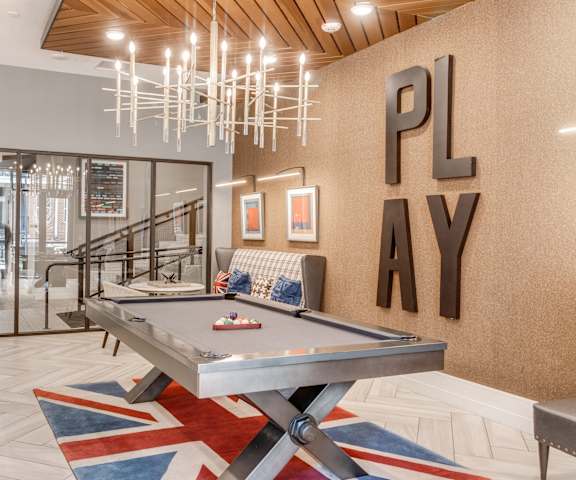 a billiards table in a game room with a ping pong at Dartmoor Place at Oxford Square Apartments, Hanover, Maryland