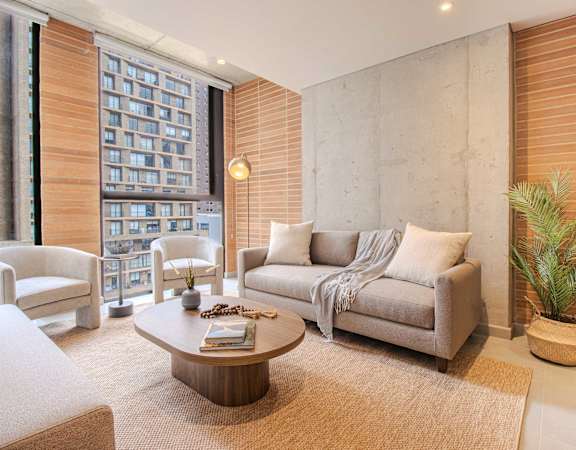 A living room with a couch, armchair, and coffee table.