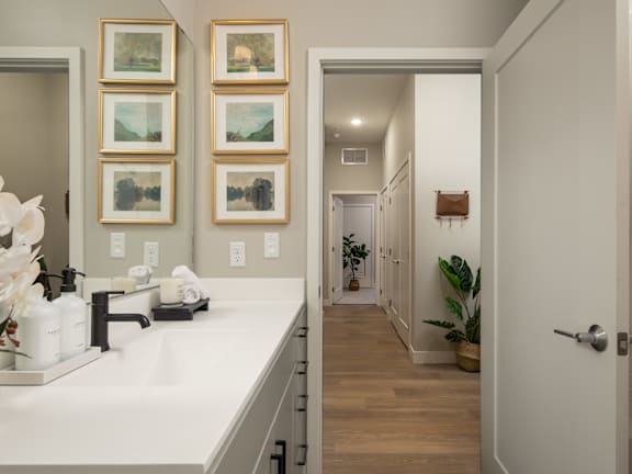 a bathroom with a sink and a door to a hallway