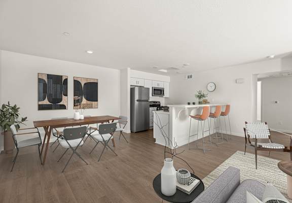 a living room and dining room with a table and chairs