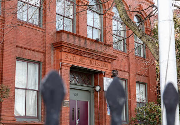 a red brick building with a green door