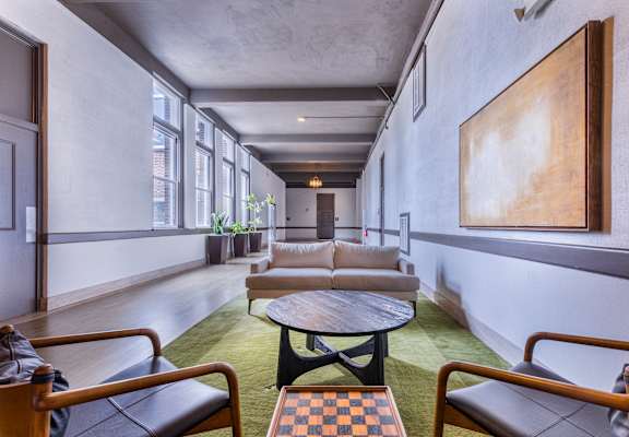 a living room with couches and chairs and a table