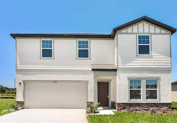 A two-story house with a garage and a brown door.