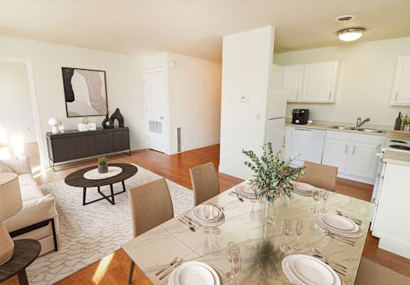 a living room and dining room with a table and chairs