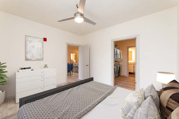 a bedroom with a large bed and a ceiling fan