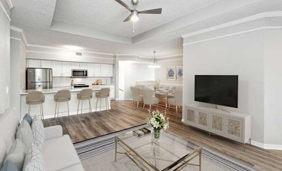 a living room with a couch a coffee table and a tv at The Ashlar, Fort Myers, FL