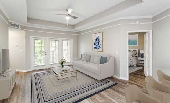 a living room with a couch and a coffee table at The Ashlar, Fort Myers, FL, 33907