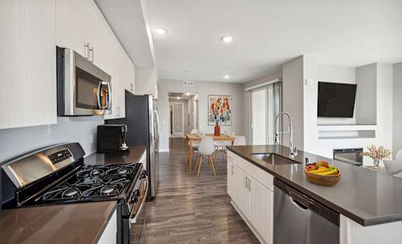a kitchen and living room with a stove and a sink at Lumina at Spanish Springs, Nevada
