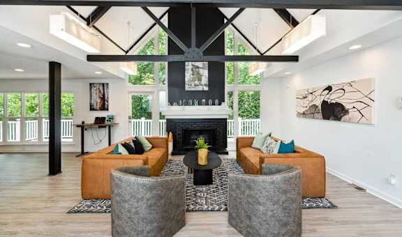 a living room with couches and chairs and a fireplace