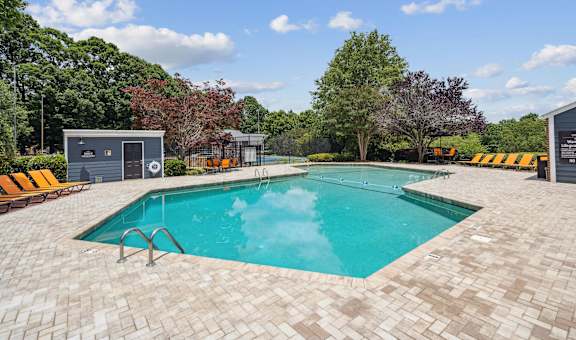 a swimming pool in the backyard of a house with a pool
