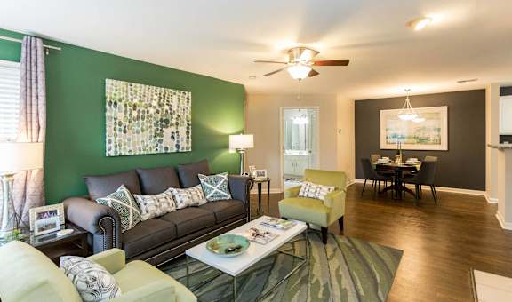 a living room with a green accent wall and a couch