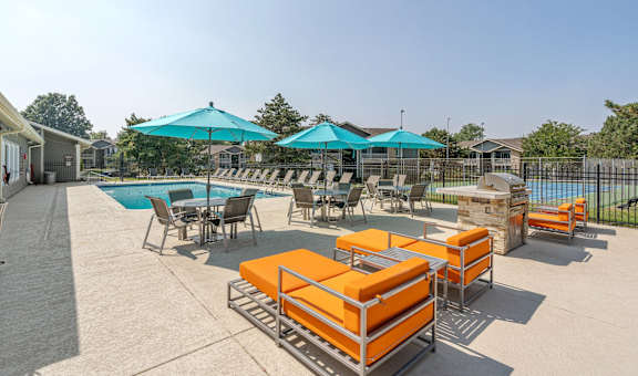 our apartments have a pool and lounge area with chairs and umbrellas
