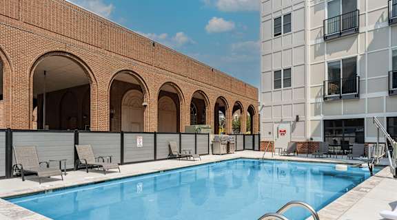 a swimming pool in front of a building at The Constellation Apartments, PRG Real Estate, Virginia