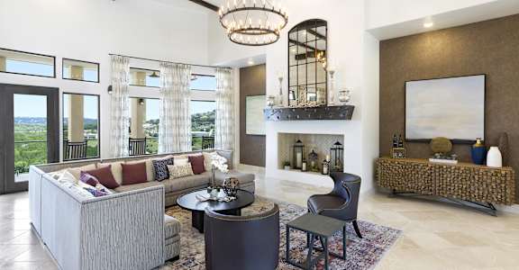 a living room with couches and chairs and a fireplace