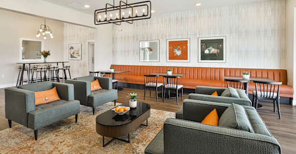a living room with couches and chairs and a dining room with tables