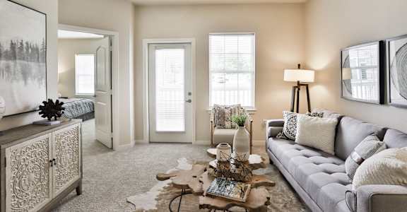 a living room with a couch and a coffee table  at Aventura at Hawk Ridge, Lake St Louis, MO
