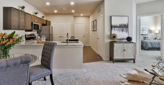 an open kitchen and living room with a couch and a table