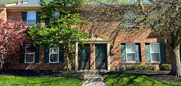 a brick house with a tree in front of itat Revere Village Apartments, Centerville, OH, 45458