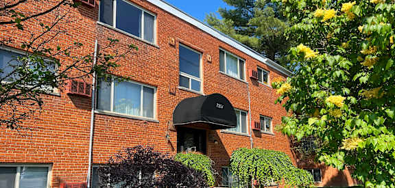 a brick apartment building with a black awning at Crown Court Apartments, Kentucky, 41042