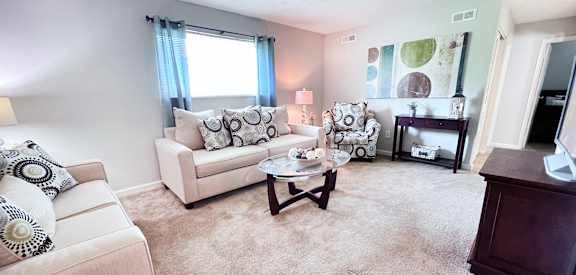 A living room with a white couch and a coffee table.