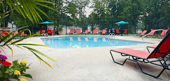 our resort style swimming pool is filled with chairs and umbrellas  at Hunter's Creek Apartments, Cincinnati, 45242