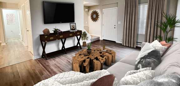 A modern living room with a large bed in the foreground.