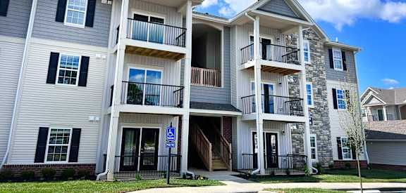 Apartment building with a blue sign on the ground.