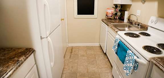a kitchen with white appliances and a sink and refrigerator at Oakwood Apartments, Florence, KY, 41042