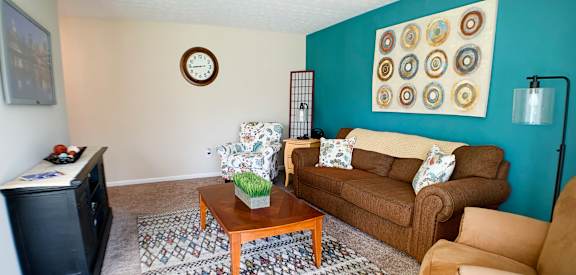 a living room with a couch and a coffee table  at Timber Ridge Apartments, Cincinnati