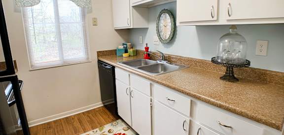 a kitchen with white cabinets and a counter top and a sink  at Hunter's Creek Apartments, Cincinnati, 45242