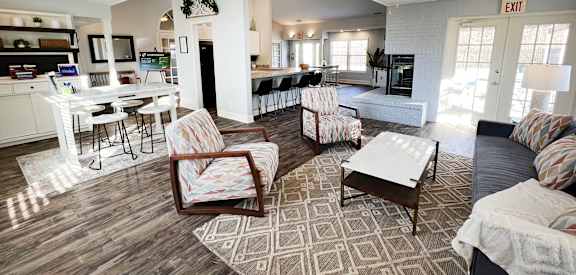a view of a living room with chairs and a table  at Woodhills Apartments, West Carrollton, Ohio