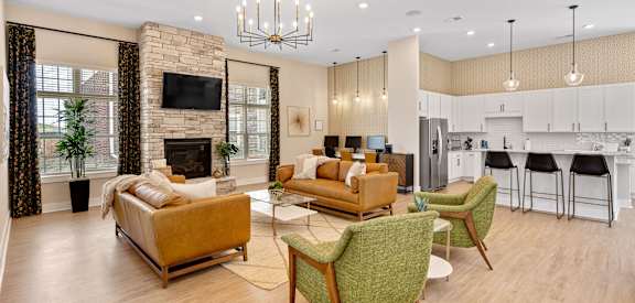 a living room with couches and chairs and a fireplace
