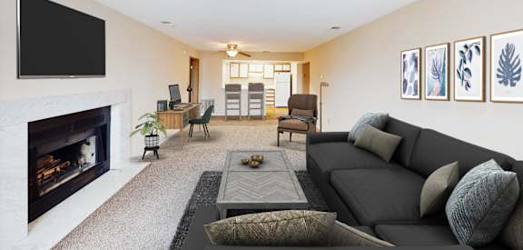 a living room with a black couch and a fireplace  at Woodhills Apartments, West Carrollton, Ohio