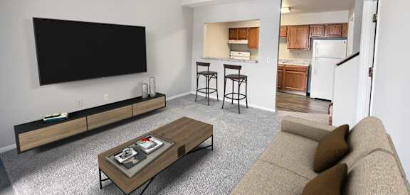 A living room with a couch, a coffee table, and a television.