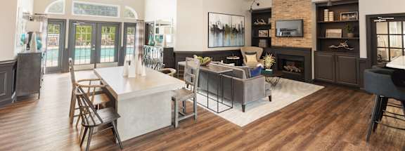 A modern living room with a fireplace and a dining table.
