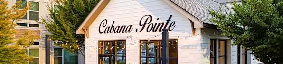 A white building with a black awning that says Cabana Pointe.