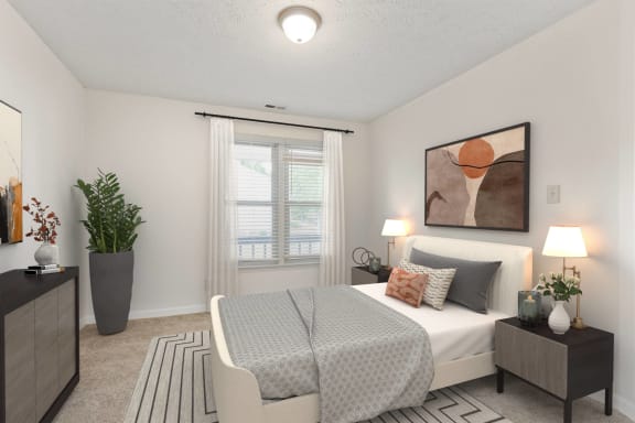 a bedroom with a bed and a window and a potted plant