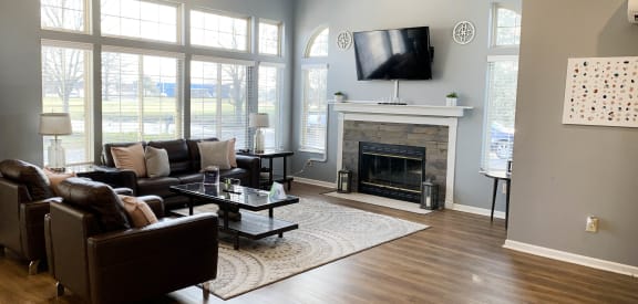 a living room with a fireplace and a tv above it  at Eagle Crest Apartments, Galloway, OH, 43119
