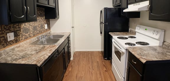 a kitchen with black and white appliances and granite counter tops at Hunter Ridge Apartments, Ohio, 45244